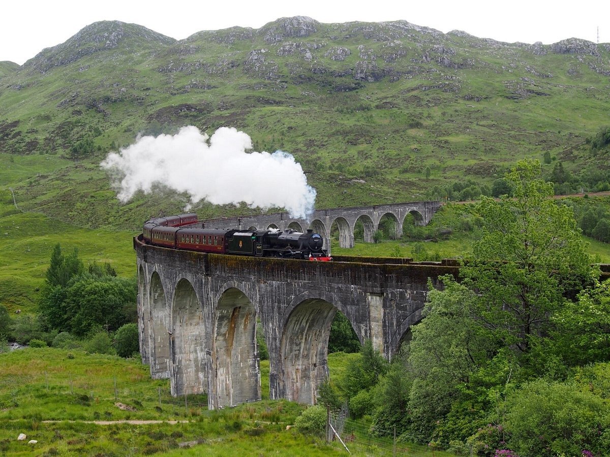 Steam train crossing the Glenfinnan Viaduct, Scotland